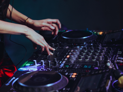 dj spinning track at party. neon colors, having fun
