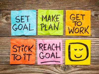 colorful sticky notes that says set goal, make plan, get to work, stick to it, and reach goal.